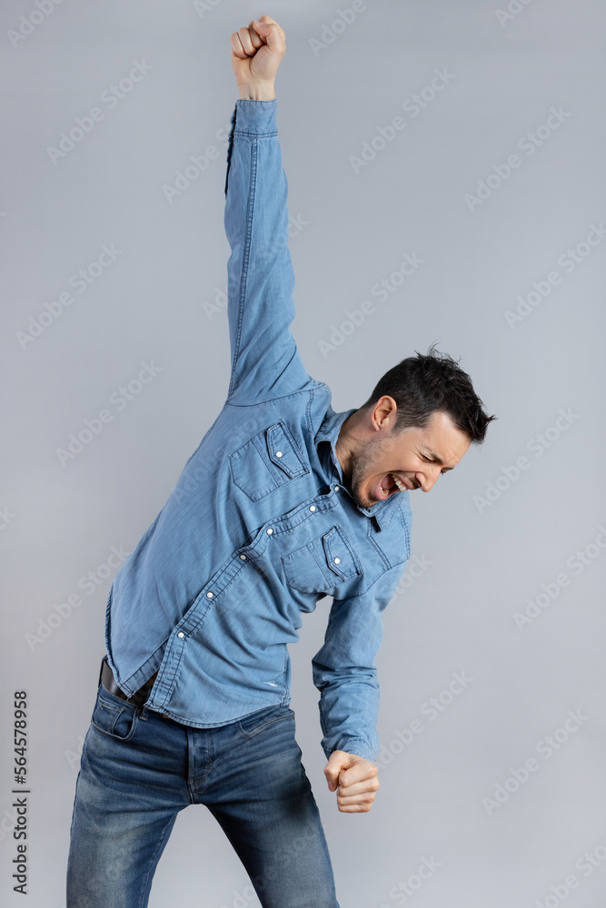 Happy young Man with casual jeans clothes doing winner gesture Happy young Man with casual jeans clothes doing winner gesture