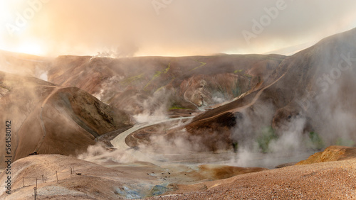 Beautiful hilly landmark of orange and red Kerlingarfjöll mountains in iceland with steam comming out from geothermal areas, snowy areas and river on the valley © michnik101
