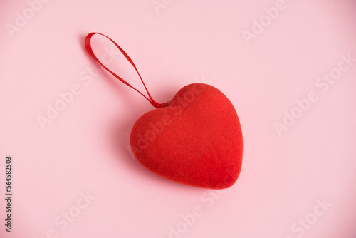 Valentine's Day celebration concept. Red heart on pink paper background with copy space, flat lay