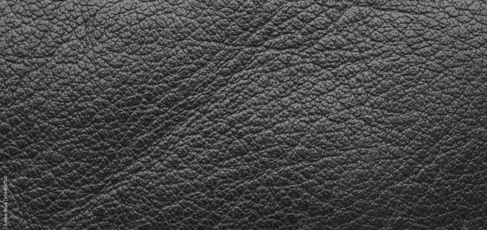 Texture of a fine black leather surface using as background or header