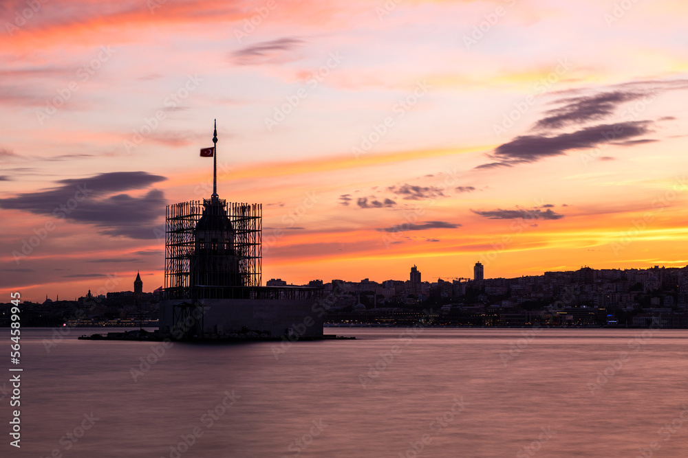 Maiden tower repair. View of Maiden's Tower and Galata Tower from Üsküdar at sunset. Maiden's tower long exposure.