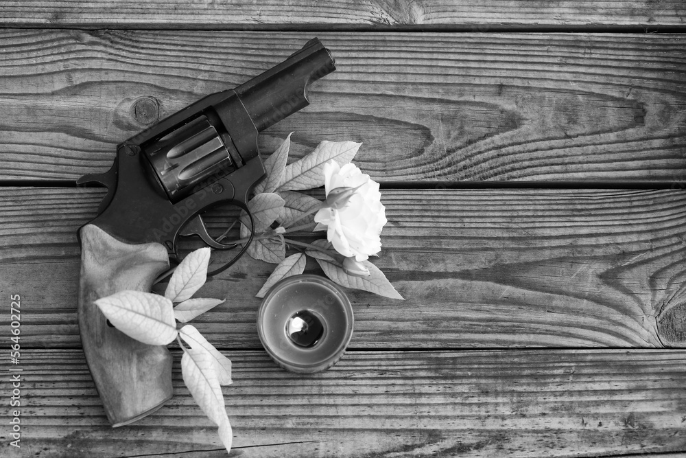 vintage still life with gun and rose in black and white