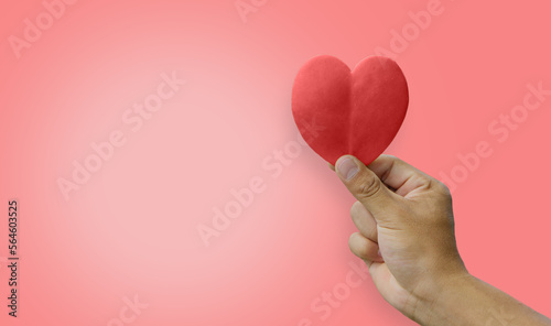 Hand holding red heart with pink background.copy space.Valentines day concept.