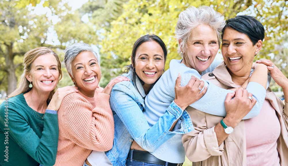 Obraz premium Friends, park and group of women hug enjoying bonding, quality time and relax in nature together. Diversity, friendship and portrait of happy senior females with smile, embrace and peace outdoors