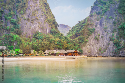 small resort by the sea under the rocky cliffs of Halong bay in south china sea © Alevtina