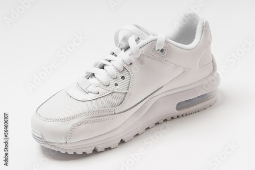 Leather trainers with a shadow on white background