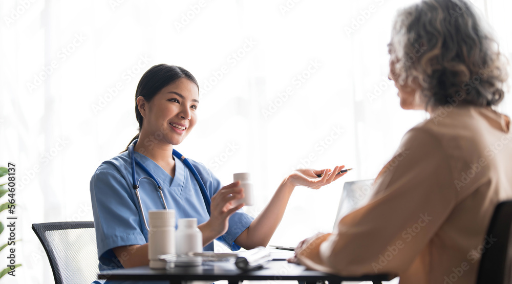 Asian Senior elderly female patient consult with physician nurse at nursing home care. Caregiver therapist pharmacist girl hold medicine pills bottle Asian Senior elderly female patient consult with physician nurse at nursing home care. Caregiver therapist pharmacist girl hold medicine pills bottle