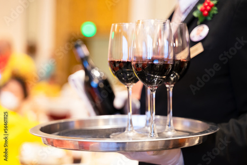Wine glasses in a tray ready to be served by staff serving at a party in a luxury hotel