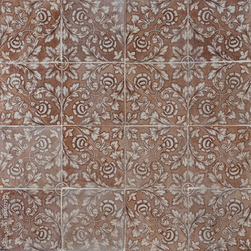 Faded, not corrected, vintage azulejos, glazed ceramic tiles with ornaments on building wall. Heritage Concept of traditional Portuguese art.