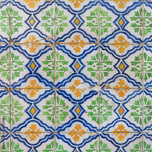Damaged, dirty, not corrected, vintage azulejos, glazed ceramic tiles with ornaments on building wall. Heritage Concept of traditional Portuguese art.