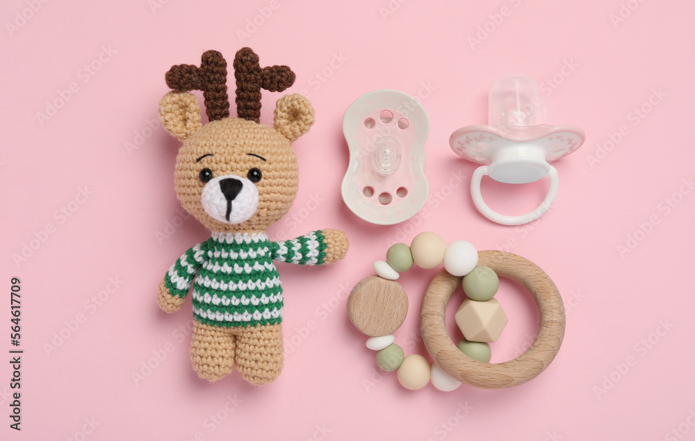 Flat lay composition with pacifiers and other baby stuff on pink background Flat lay composition with pacifiers and other baby stuff on pink background