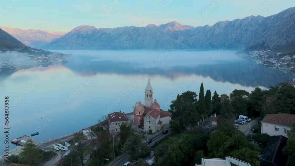Temple in the Coast of Kotor bay. Aerial view. Morning time. Fog over the water Temple in the Coast of Kotor bay. Aerial view. Morning time. Fog over the water