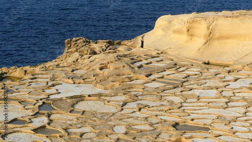 Interesting patterns made by Sea salt production on the island of Gozo.  Ancient salt pans photo