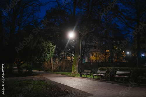 Pavement and benches in the night evening city park