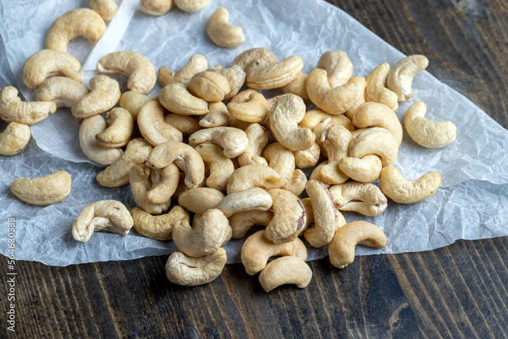 Hard roasted and peeled cashew nuts on the table Hard roasted and peeled cashew nuts on the table