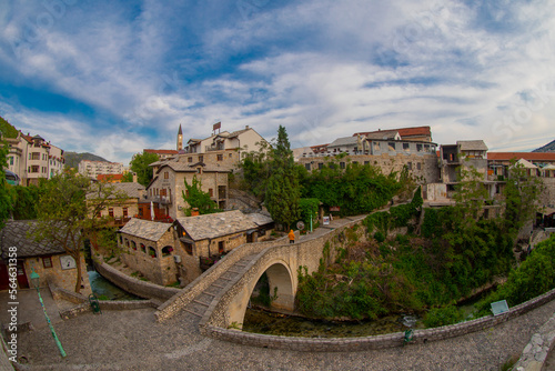View of the Crooked Bridge (Kriva Cuprija) one of the oldest bridges in Mostar built in 1558. photo