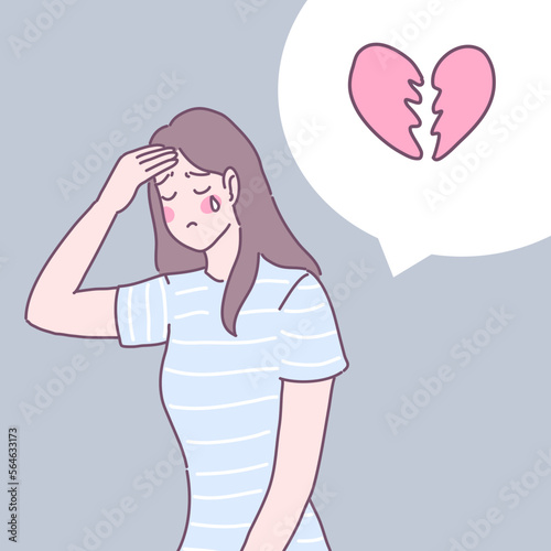 A woman standing heartbroken and having a headache