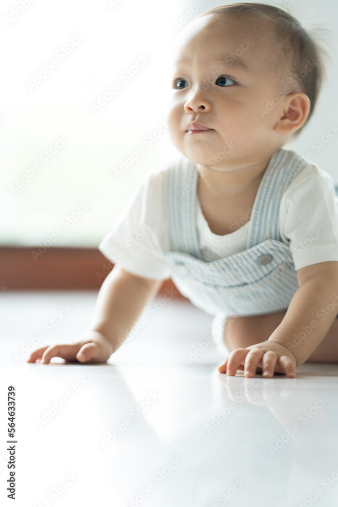 Chubby ginger baby boy in bodysuit, barefoot. He smiling, creeping on floor background with copy space, family fatherhood and parenthood concept, happy little baby girl with father at home Chubby ginger baby boy in bodysuit, barefoot. He smiling, creeping on floor background with copy space, family fatherhood and parenthood concept, happy little baby girl with father at home