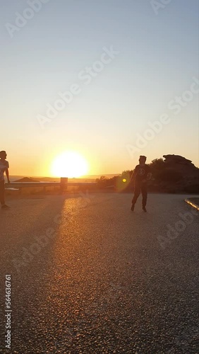 Flying kick to another person. Combat at dusk. Vertical view