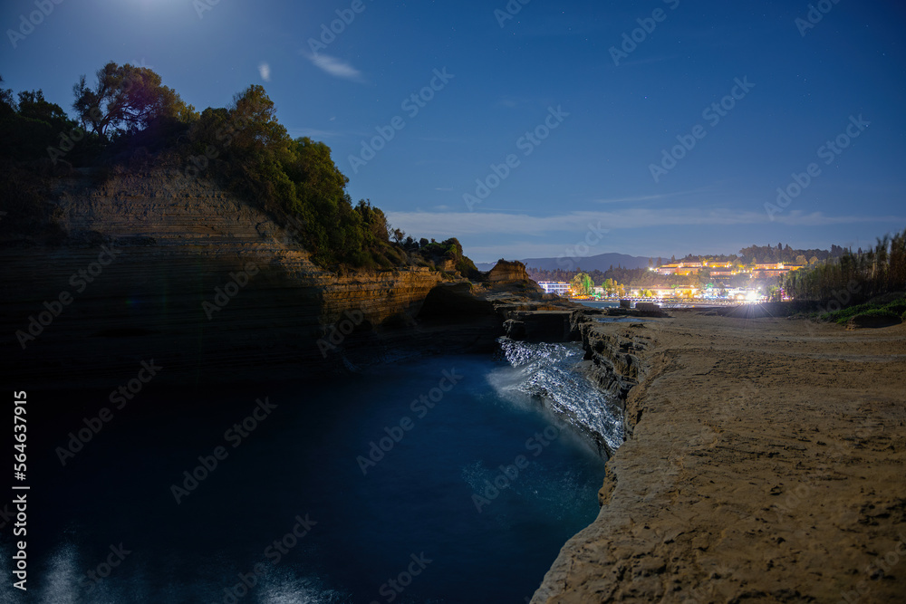 Famous Canal d'Amour beach with beautiful rocky coastline in amazing blue Ionian Sea at sunrise in Sidari holiday village on Corfu island in Greece by night 