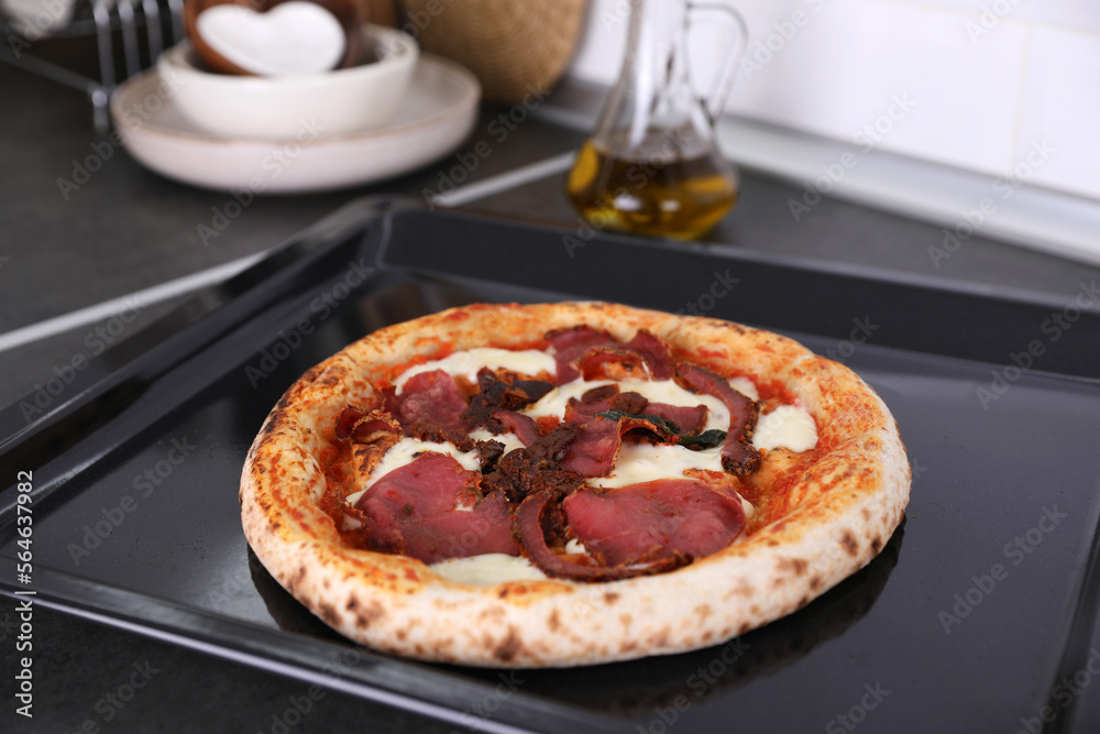 Pizza with beef on the kitchen table Pizza with beef on the kitchen table