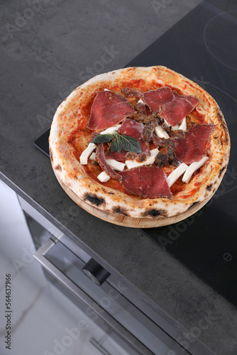 Frozen pizza with beef in the kitchen