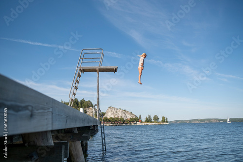 Girl jumping from diving tower