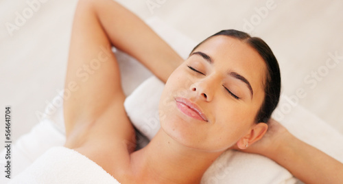 Spa, wellness and woman, calm and happy, peaceful after massage, massage therapy for body health and zen. Young person satisfied, lying down and carefree with peace and serene, stress relief.