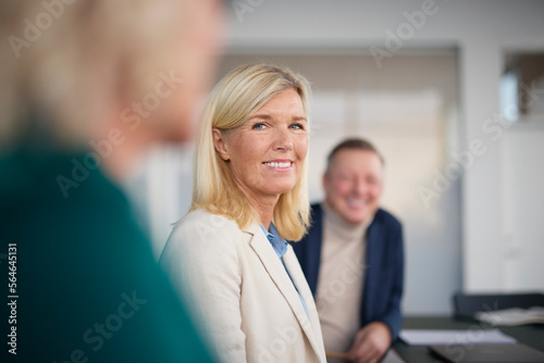 Smiling woman at business meeting photo