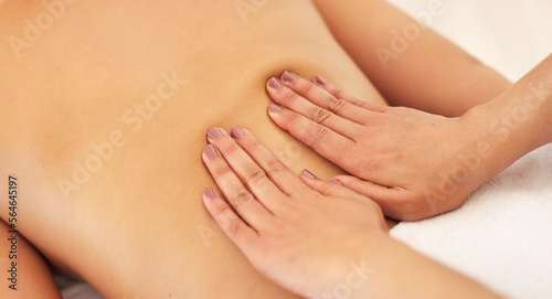 Relax  hand and therapist massage customer at luxury health and wellness spa for skincare and body treatment. Woman  physical therapy and hands on back for calm  stress relief and muscle tension