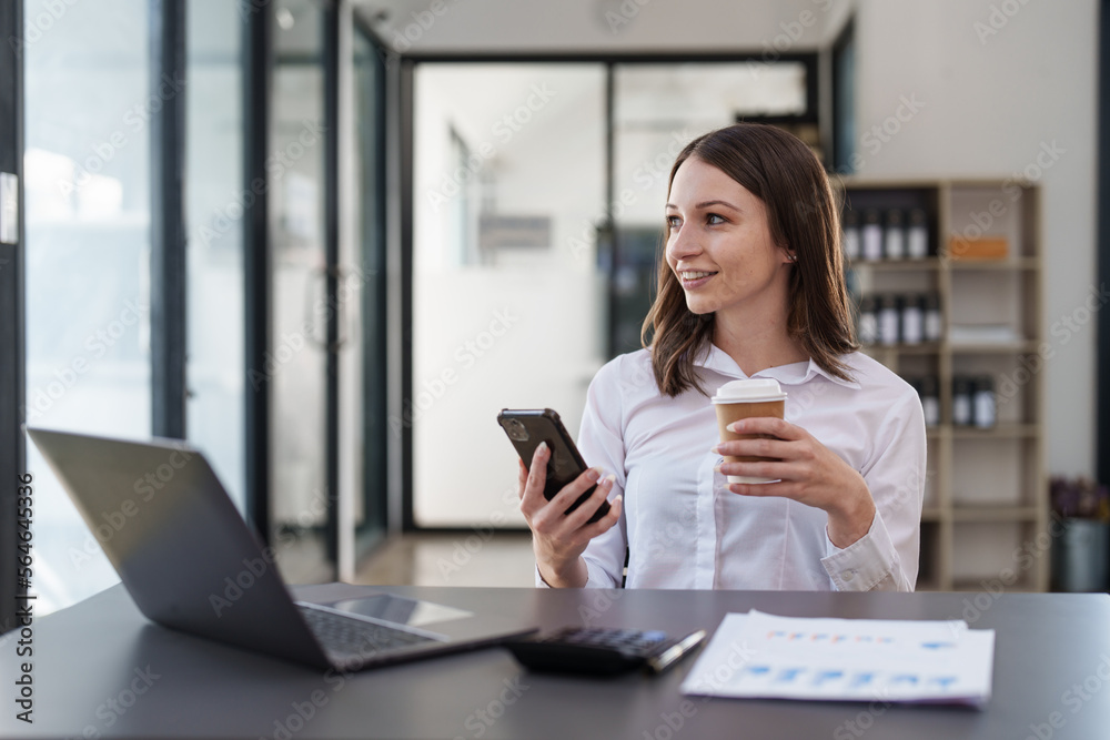Smiling asian business woman with smartphone in office. Woman in casual at office
