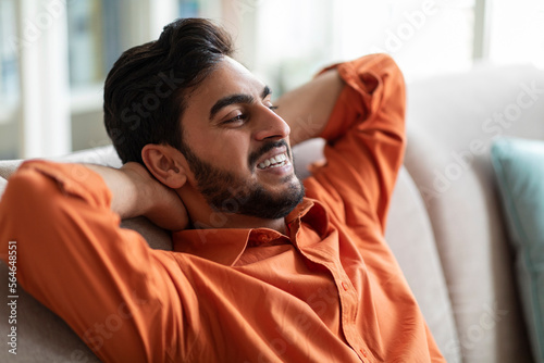 Closeup of relaxed middle eastern guy chilling at home
