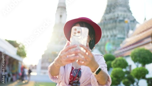 thai woman taking seflie at wat arun in bangkok thailand photo