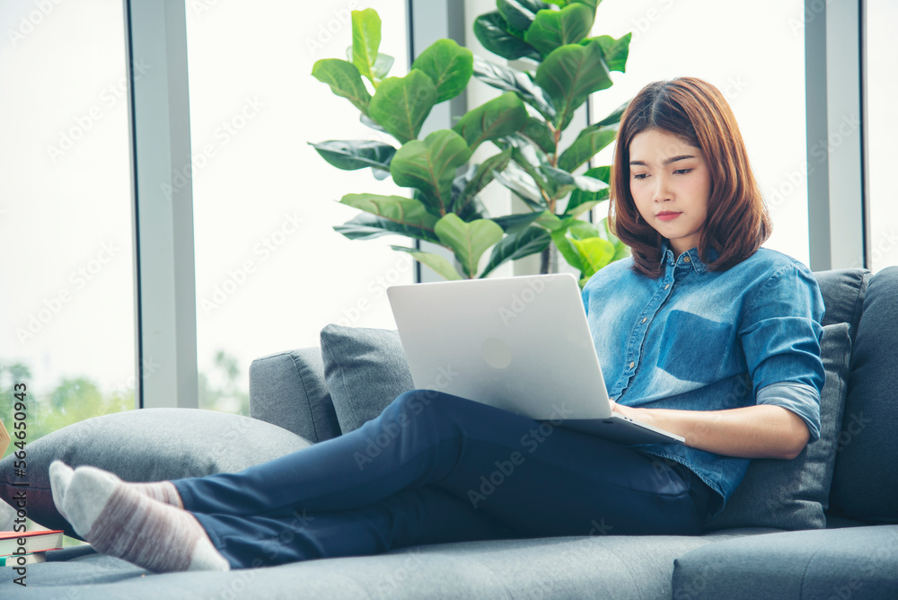 Happiness Asian Woman working from home using laptop online meeting in home office. Happy relax time asian business woman typing keyboard use notebook laptop Smiling, laughing at home office. Happiness Asian Woman working from home using laptop online meeting in home office. Happy relax time asian business woman typing keyboard use notebook laptop Smiling, laughing at home office.