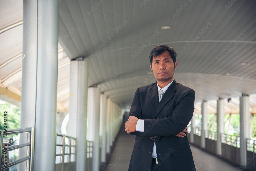 Portrait happiness businessman smiling face confident leader manager in modern city. Asian man handsome success look at camera professional manager. Men standing in suit handsome CEO leader business Portrait happiness businessman smiling face confident leader manager in modern city. Asian man handsome success look at camera professional manager. Men standing in suit handsome CEO leader business