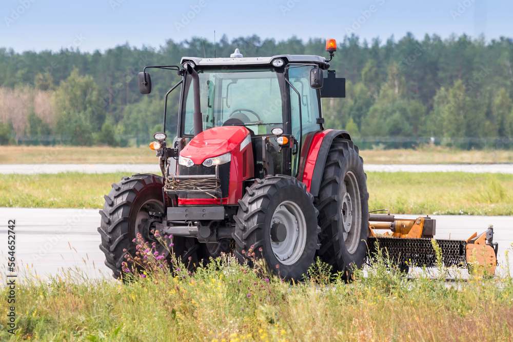 Wheeled tractor with rotary mower on the road Wheeled tractor with rotary mower on the road