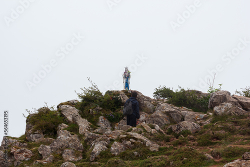 Pilgrim looking the statue of the Virgin Mary in in mountains of Pyrenees