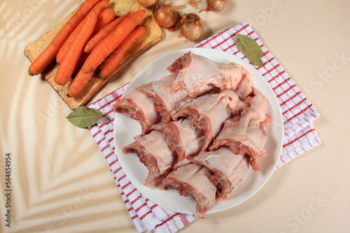 Fresh chicken skeletons and vegetables, carrots and onions. Raw chicken backs skin on bone © SHARKY PHOTOGRAPHY