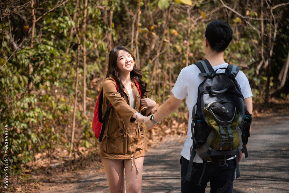 Asian smart male and beautiful female trekking and hiker in holiday together, Active young tourists relaxing in holiday, couple traveling summer adventure journey in nature outdoors.