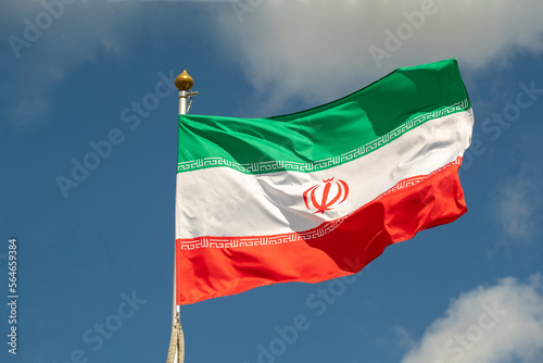 Iranian flag for advertising, celebration, achievements, festivals, elections. The Iranian flag flutters in the beautiful sky. Great for news.
