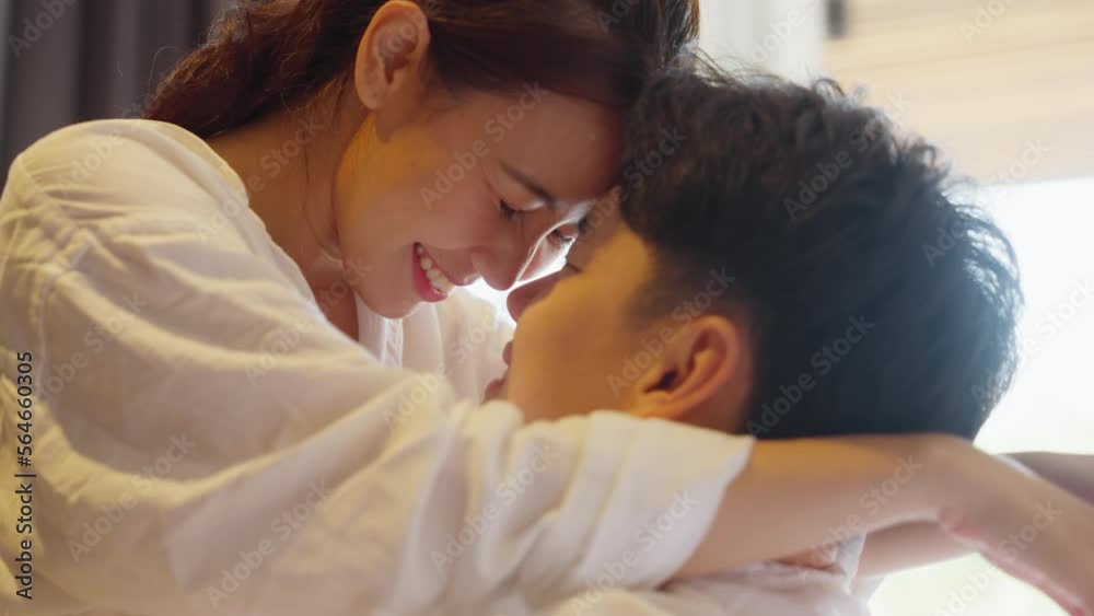 Young adult asia people fiance happy lover flirt fall in love nose lips kiss hug cuddle care trust. Sweet comfort touch newlywed asian couple life man smile look at woman face relax warm time dating.