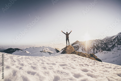 Man running on the snow at the top of a mountain