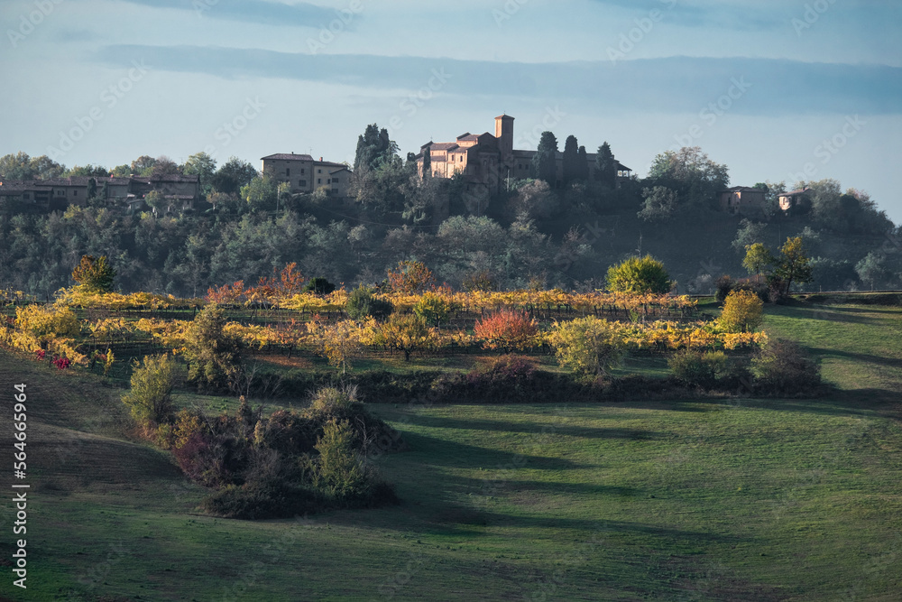 Italian countryside with autumn colored trees and vineyards
