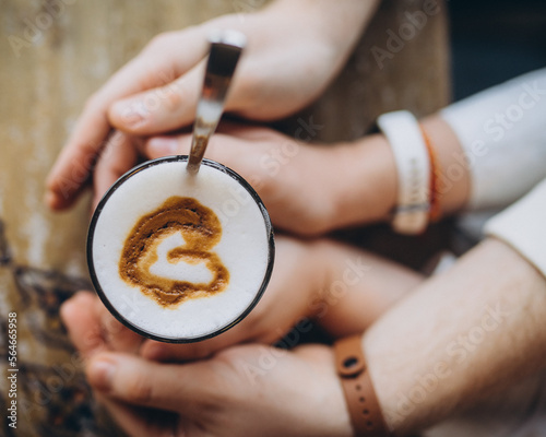 hands holding coffee cup with love sign