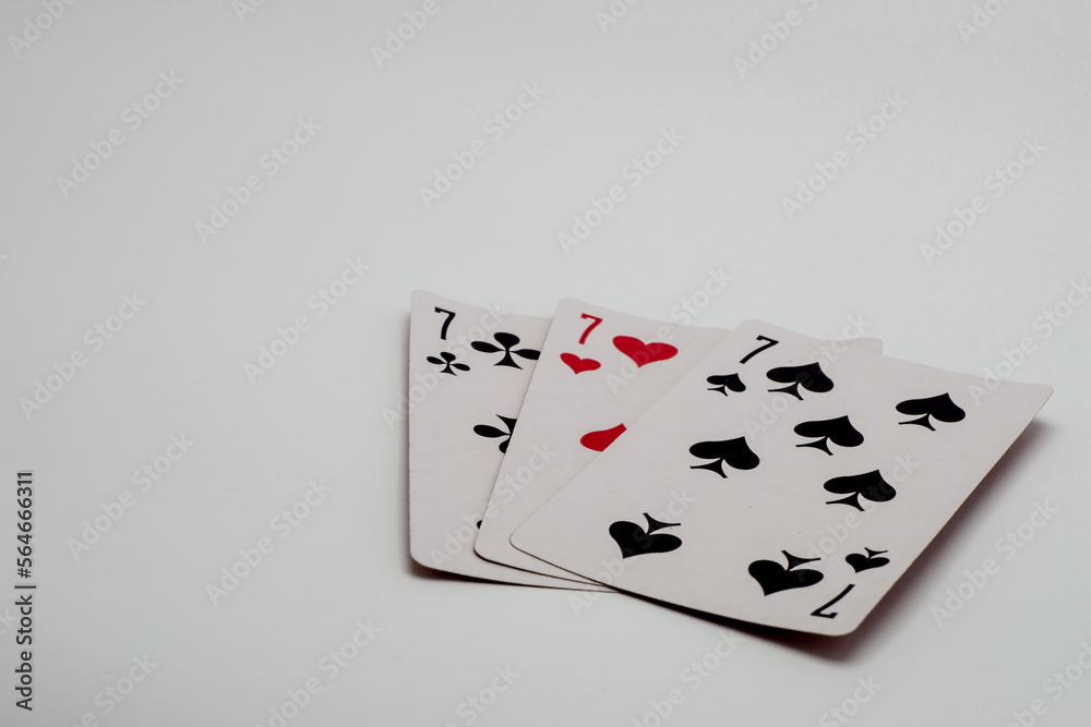 three playing cards on a white three playing cards on a white