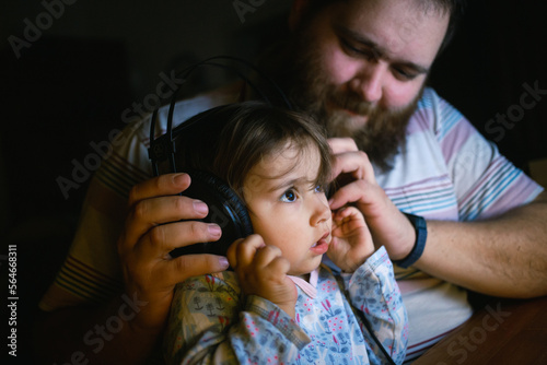 Father and daughter listening to music