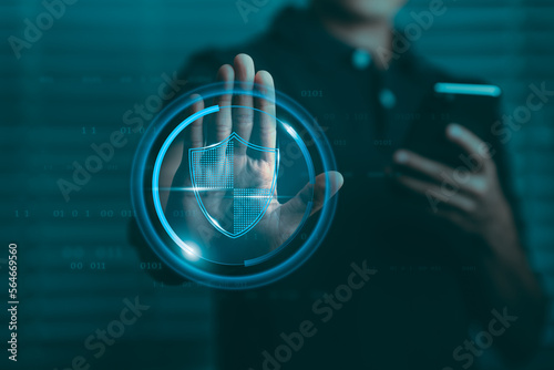 Data protection concept, businessman raising hand showing stop sign And there is a data protection symbol graphic on the palm.