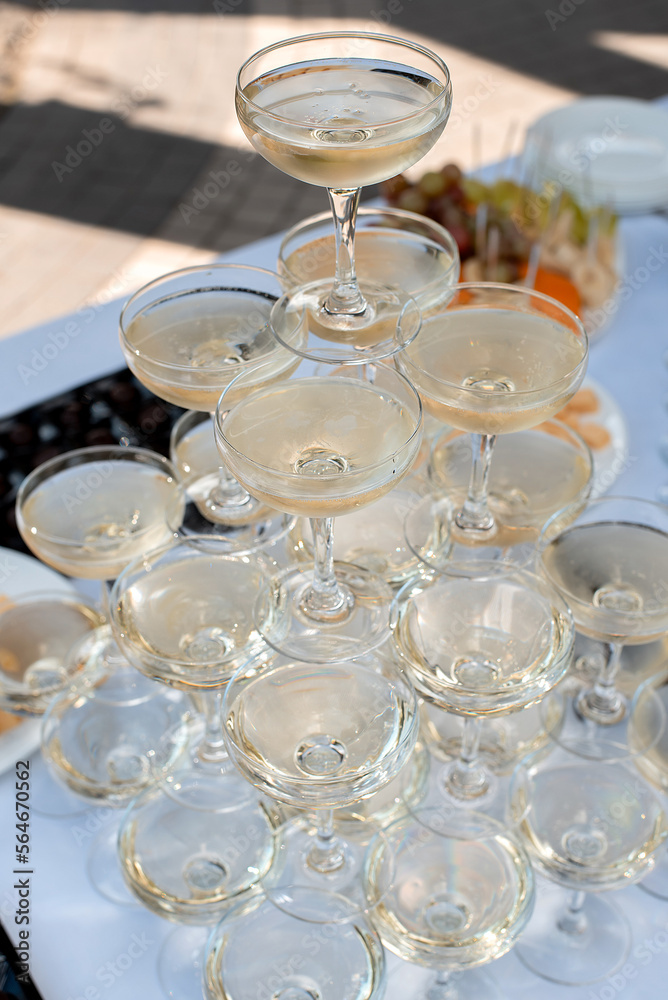 Glasses of champagne on the festive table. serving for the wedding ceremony Glasses of champagne on the festive table. serving for the wedding ceremony