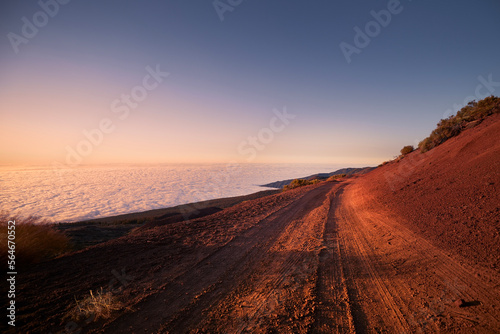 Dirt road in mountains above clouds at beautiful sunset. Tenerife  Canary Islands..