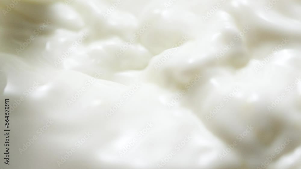 Macro slow motion pouring white milk, closeup splashing fresh drink with drops Macro slow motion pouring white milk, closeup splashing fresh drink with drops